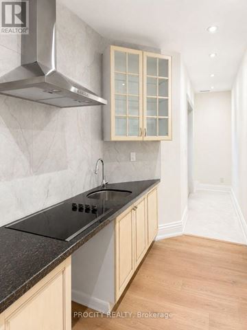 Markham (Grandview) apartment for rent - A kitchen with a stove top oven and a hood.
