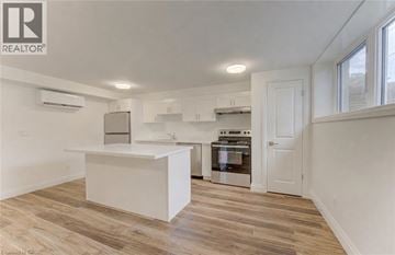 Kitchener apartment for rent - A white kitchen with a large island in the middle.