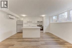 Kitchener apartment for rent - A well-lit kitchen with a white island and wooden flooring.