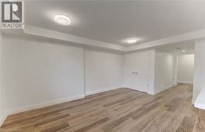 Kitchener apartment for rent - A room with wooden flooring and white walls.
