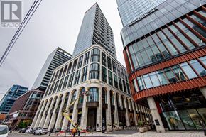 Toronto (Waterfront Communities) condo for rent - A tall building with a glass facade stands next to a building with a curved facade.