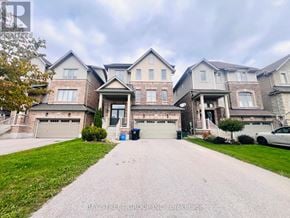 New Tecumseth apartment for rent - A large, multi-level house with a driveway in front.
