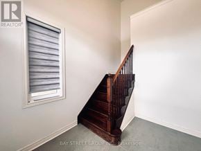 New Tecumseth apartment for rent - A wooden staircase with a window on the side.