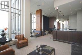 Mississauga (City Centre) condo for rent - A reception area with a desk and chairs.