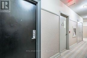 Mississauga (City Centre) condo for rent - A hallway with doors and a sign that says "REALTOR".