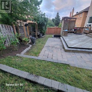 Mississauga (Hurontario) apartment for rent - A backyard with a wooden deck and a small gazebo.