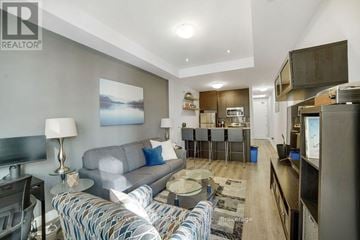 Hamilton (Central) condo for rent - A living room with a grey couch and a coffee table.