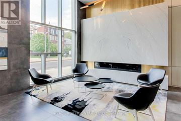 Toronto (Casa Loma) condo for rent - A living room with a white marble fireplace and black chairs.