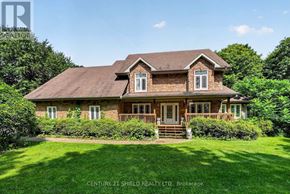 South Stormont apartment for rent - A house with a brown roof and a white door is surrounded by greenery.