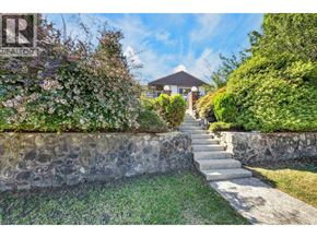 Burnaby apartment for rent - A stone wall with a staircase leading to a house.