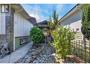 Burnaby apartment for rent - A stone pathway leads to a patio with a table and chairs.
