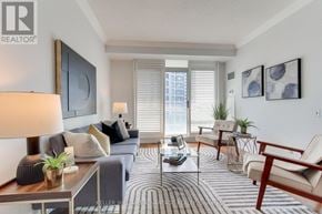 Toronto (Mimico) condo for rent - A living room with a grey couch, a coffee table, and a rug.