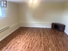St. John's apartment for rent - A room with wooden flooring and a cabinet.