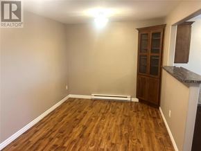 St. John's apartment for rent - A room with wooden flooring and a cabinet.