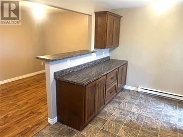 St. John's apartment for rent - A kitchen with wooden cabinets and a marble countertop.