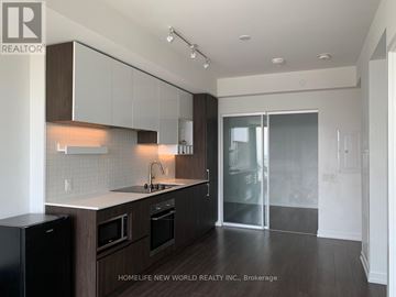 Vaughan (Vaughan Corporate Centre) condo for rent - A modern kitchen with dark wood cabinets and a black trash can.