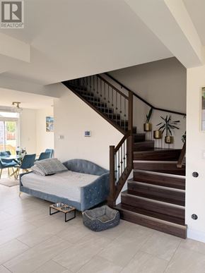 Sault Ste. Marie apartment for rent - A bedroom with a bed and a staircase.