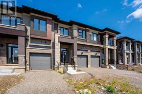 Brantford townhouse for rent - A row of new houses with garages are for sale.
