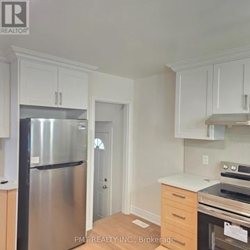 Waterloo apartment for rent - A kitchen with white cabinets and a stainless steel refrigerator.