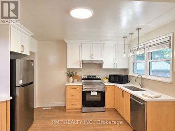 Waterloo apartment for rent - A kitchen with a black fridge and stove top oven.