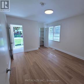 Waterloo apartment for rent - A room with wooden flooring and white walls, with a door leading outside.