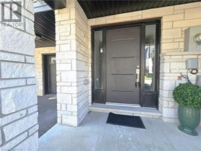 Cambridge townhouse for rent - A house entrance with a black door and a green plant.