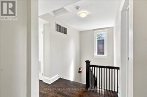 Toronto (Yonge-St. Clair) fourplex for rent - A hallway with a window and a fireplace.