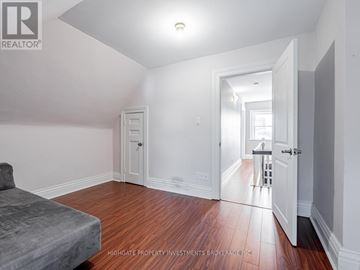 Toronto (Little Portugal) apartment for rent - A bedroom with a bed and a doorway leading to another room.