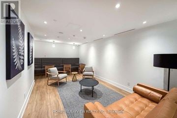 Toronto (Downsview-Roding-Cfb) condo for rent - A living room with a brown leather couch and a black coffee table.