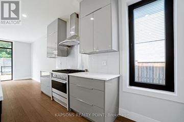 London South (South V) apartment for rent - A modern kitchen with white cabinets and stainless steel appliances.