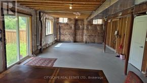 Hamilton (Waterdown) apartment for rent - A room under construction with exposed wooden beams and insulation on the walls.