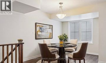 Milton (Fo Ford) townhouse for rent - A dining room with a glass table and chairs.
