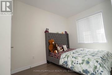 Caledon apartment for rent - A bedroom with a bed and a window with blinds.