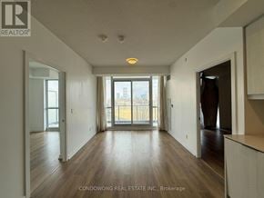 Toronto (Henry Farm) condo for rent - A spacious room with wooden floors and a large window overlooking a cityscape.