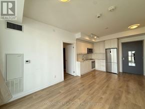 Toronto (Henry Farm) condo for rent - A kitchen area with a refrigerator, microwave, and oven.
