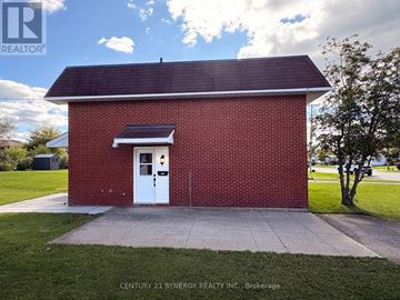 Carleton Place apartment for rent - A small red brick building with a white door and a solar panel above it.