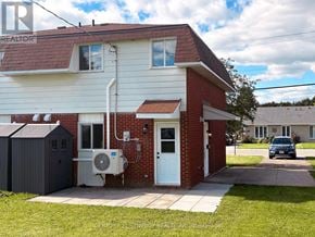 Carleton Place apartment for rent - A house with a red roof and a white door is shown.
