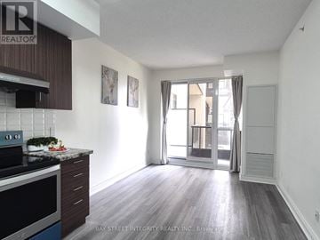 Markham (Unionville) condo for rent - A kitchen with a stove top oven and a counter top.