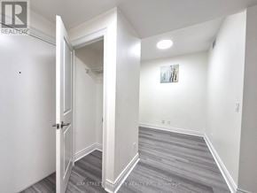 Markham (Unionville) condo for rent - A hallway with a door on the left and a painting on the wall.