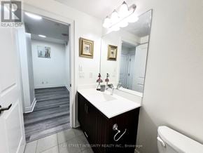 Markham (Unionville) condo for rent - A bathroom with a sink, mirror, and toilet.