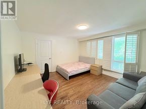 Markham (Unionville) apartment for rent - A bedroom with a bed, a couch, a chair, and a television.