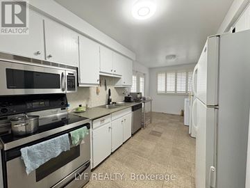 Markham (Unionville) apartment for rent - A well-lit kitchen with white cabinets and appliances.