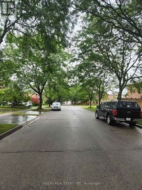 Ajax (Central West) apartment for rent - A wet street with a truck and a car on it.