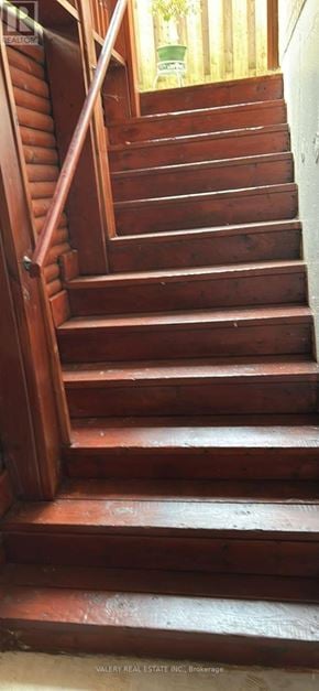 Ajax (Central West) apartment for rent - A wooden staircase with a handrail on the left side.