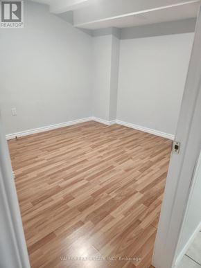 Ajax (Central West) apartment for rent - A room with wooden flooring and white walls.