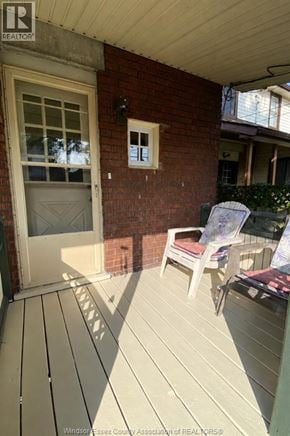 Windsor apartment for rent - A wooden deck with a white door and a small window.