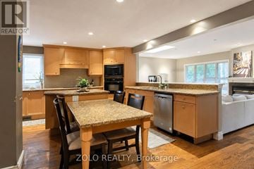 Mississauga (Erin Mills) apartment for rent - A kitchen with wooden cabinets and a granite countertop.