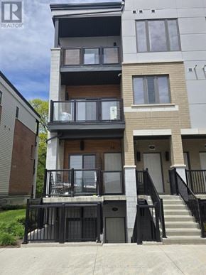 Cambridge townhouse for rent - A modern two-story apartment building with balconies and black railings.