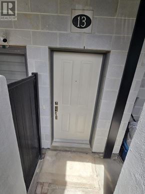Cambridge townhouse for rent - A white door with a black frame is on the ground floor of a building.