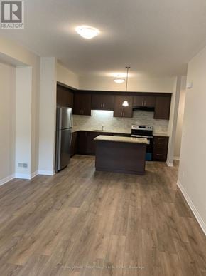 Cambridge townhouse for rent - A kitchen with wooden floors and white walls.